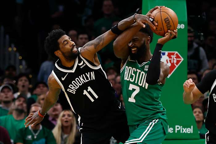 Kyrie Irving wears Air Jordan 1 Low 'Travis Scott' sneakers and Jaylen Brown wears Yeezy 700.